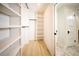 Organized walk-in closet with white shelving offering ample storage space and wooden floors at 264 Haas Ave, Atlanta, GA 30316