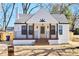 Charming renovated home with a crisp white exterior, black accents, and inviting front porch at 264 Haas Ave, Atlanta, GA 30316