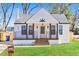 Charming renovated home boasts fresh white paint, modern porch railing, and beautifully manicured lawn at 264 Haas Ave, Atlanta, GA 30316
