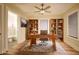 Office with wood floors, built-in shelves, a ceiling fan, and a view of an adjacent bathroom at 264 Haas Ave, Atlanta, GA 30316