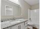 Bathroom featuring granite counters, modern fixtures, white cabinetry, and shower and tub combination at 841 Lake Hollow Sw Blvd, Marietta, GA 30064