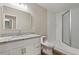 Updated bathroom features a white vanity with granite countertop and a shower with glass door at 841 Lake Hollow Sw Blvd, Marietta, GA 30064