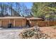 Charming tan home with attached garages, set amidst trees and landscape at 841 Lake Hollow Sw Blvd, Marietta, GA 30064