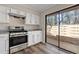 Well-lit kitchen with stainless steel oven, white cabinets, granite countertops, and access to the patio at 841 Lake Hollow Sw Blvd, Marietta, GA 30064