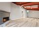 Open living space with a stone fireplace, ceiling fan, and skylights for natural light at 841 Lake Hollow Sw Blvd, Marietta, GA 30064