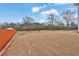 A spacious backyard featuring a lawn with mature trees, offering plenty of room for recreation at 210 Meadow View Dr, Grayson, GA 30017