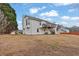 Exterior view showcasing the back of the home with a deck and spacious backyard at 210 Meadow View Dr, Grayson, GA 30017