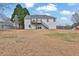 Exterior view of the back of the house highlighting the deck and large backyard at 210 Meadow View Dr, Grayson, GA 30017
