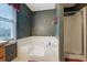 Bathroom featuring bathtub with shower and patterned wall paper at 210 Meadow View Dr, Grayson, GA 30017