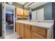 Bathroom with double sinks, linen closet, and a doorway to bedroom at 210 Meadow View Dr, Grayson, GA 30017