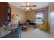 Bedroom featuring ceiling fan, window, and writing desk at 210 Meadow View Dr, Grayson, GA 30017