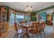 Inviting dining room featuring a chandelier, decorative wallpaper, and an adjacent living room at 210 Meadow View Dr, Grayson, GA 30017