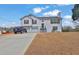 Charming two-story home featuring vinyl siding, red shutters, and an attached two-car garage at 210 Meadow View Dr, Grayson, GA 30017