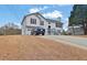 Two-story home with vinyl siding, red shutters, attached garage, and a long driveway at 210 Meadow View Dr, Grayson, GA 30017