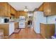 Cozy kitchen featuring wooden cabinets, appliances, and hardwood floors at 210 Meadow View Dr, Grayson, GA 30017