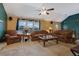 Cozy living room with stone fireplace, plush seating, and a ceiling fan at 210 Meadow View Dr, Grayson, GA 30017