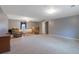 Large living room features neutral carpet, a ceiling fan, and a comfortable seating arrangement at 210 Meadow View Dr, Grayson, GA 30017