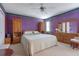 Spacious main bedroom with carpeted floors and lots of wooden furniture at 210 Meadow View Dr, Grayson, GA 30017