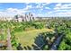 Aerial view of a large, green park in Atlanta with a cityscape in the background under a blue, cloudy sky at 220 Renaissance Ne Pkwy # 1105, Atlanta, GA 30308