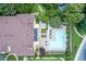 Aerial view of pool, landscaping, and building featuring a dark roof and lush foliage at 220 Renaissance Ne Pkwy # 1105, Atlanta, GA 30308