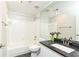 Bathroom featuring granite counters, a tile floor, and a shower-tub combo at 220 Renaissance Ne Pkwy # 1105, Atlanta, GA 30308