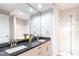 Bright bathroom boasts granite countertop, double sinks and a glass enclosed shower at 220 Renaissance Ne Pkwy # 1105, Atlanta, GA 30308