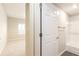 Bathroom with a shower-tub combo and tile surround, accessible from the carpeted bedroom at 220 Renaissance Ne Pkwy # 1105, Atlanta, GA 30308