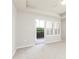 Bedroom features a door to the patio and windows with white shutters at 220 Renaissance Ne Pkwy # 1105, Atlanta, GA 30308
