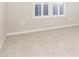 Neutral bedroom featuring a large window, plush carpet, and light colored walls at 220 Renaissance Ne Pkwy # 1105, Atlanta, GA 30308