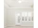 Bright bedroom with door leading to a balcony and windows with plantation shutters at 220 Renaissance Ne Pkwy # 1105, Atlanta, GA 30308