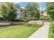 Serene landscaping with a stone fountain feature, green grass, and walkways at 220 Renaissance Ne Pkwy # 1105, Atlanta, GA 30308