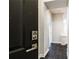 Modern entryway featuring a black front door with digital keypad entry, dark tile flooring, and neutral walls at 220 Renaissance Ne Pkwy # 1105, Atlanta, GA 30308