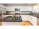 Modern kitchen with stainless steel appliances, granite countertops, and white cabinetry at 220 Renaissance Ne Pkwy # 1105, Atlanta, GA 30308