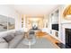 Open living room with columns, fireplace, hardwood floors, and views of the dining area at 220 Renaissance Ne Pkwy # 1105, Atlanta, GA 30308