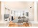 Bright living room featuring large windows, hardwood floors, and built-in shelving and fireplace at 220 Renaissance Ne Pkwy # 1105, Atlanta, GA 30308