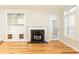 Bright living room with a marble fireplace, built-in shelving and hardwood floors at 220 Renaissance Ne Pkwy # 1105, Atlanta, GA 30308