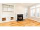 Bright living room with a marble fireplace, built-in shelving and hardwood floors at 220 Renaissance Ne Pkwy # 1105, Atlanta, GA 30308