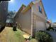 Exterior side view of home with attached two car garage and green grass at 3208 Baylor Cir, Mcdonough, GA 30253