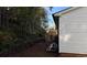 Backyard with an area of dense trees and wood retaining wall, providing privacy at 4778 Pebble Trce, Buford, GA 30518