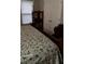 Bedroom with plush floral comforter, light from the window, and dark wood furnishings at 4778 Pebble Trce, Buford, GA 30518