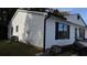 A corner view of the house with white siding and black window trim on a sunny day at 4778 Pebble Trce, Buford, GA 30518