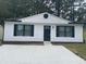 Charming single story house featuring a symmetrical front facade, white siding and minimalist landscaping at 4778 Pebble Trce, Buford, GA 30518