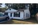 Lovely house with white siding, black trim, a well-maintained lawn, and a concrete driveway at 4778 Pebble Trce, Buford, GA 30518