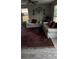 Cozy living room featuring a large ornate rug, neutral walls, and comfortable white couches at 4778 Pebble Trce, Buford, GA 30518