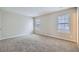 A carpeted room with two windows and blinds allows natural light at 11111 Shannon Cir, Hampton, GA 30228
