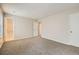 Carpeted bedroom has a neutral color scheme and a door to an ensuite bathroom at 11111 Shannon Cir, Hampton, GA 30228