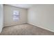 Small carpeted bedroom featuring neutral walls and natural light from a window at 11111 Shannon Cir, Hampton, GA 30228