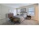Serene bedroom featuring neutral color palette, plush carpet, and ample natural light at 11111 Shannon Cir, Hampton, GA 30228