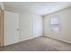 This is a bedroom with carpet, a window and a closet at 11111 Shannon Cir, Hampton, GA 30228