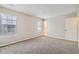 Spacious bedroom featuring neutral walls, plush carpeting, and natural light from two windows at 11111 Shannon Cir, Hampton, GA 30228